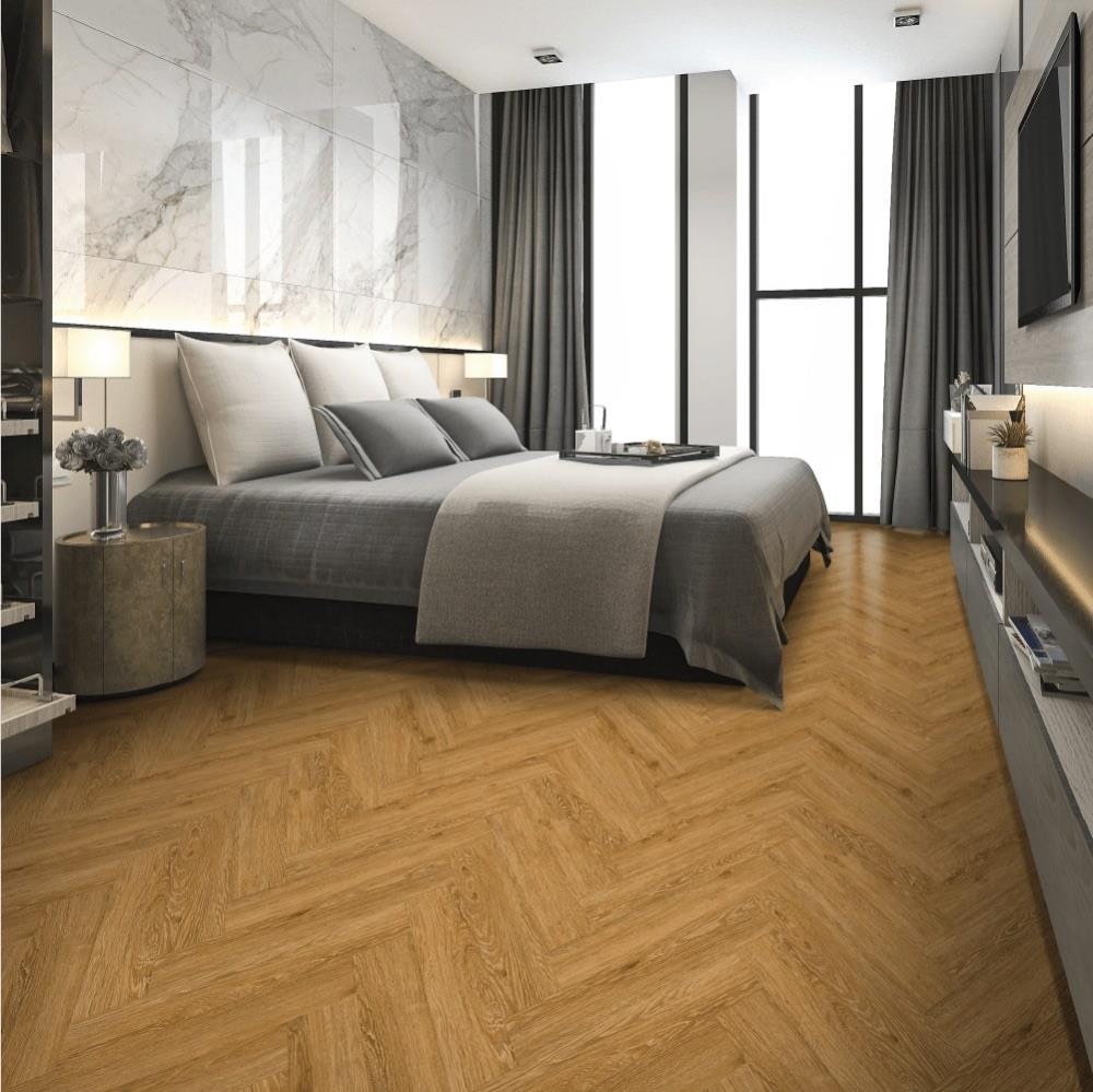 Supplier range image — golden oak herringbone LVT in a bedroom